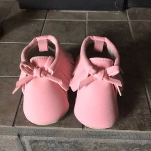 14 pairs of baby girl shoes.